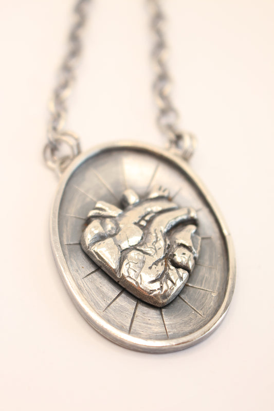 Sterling Silver necklace featuring an Anatomical heart in the Center.